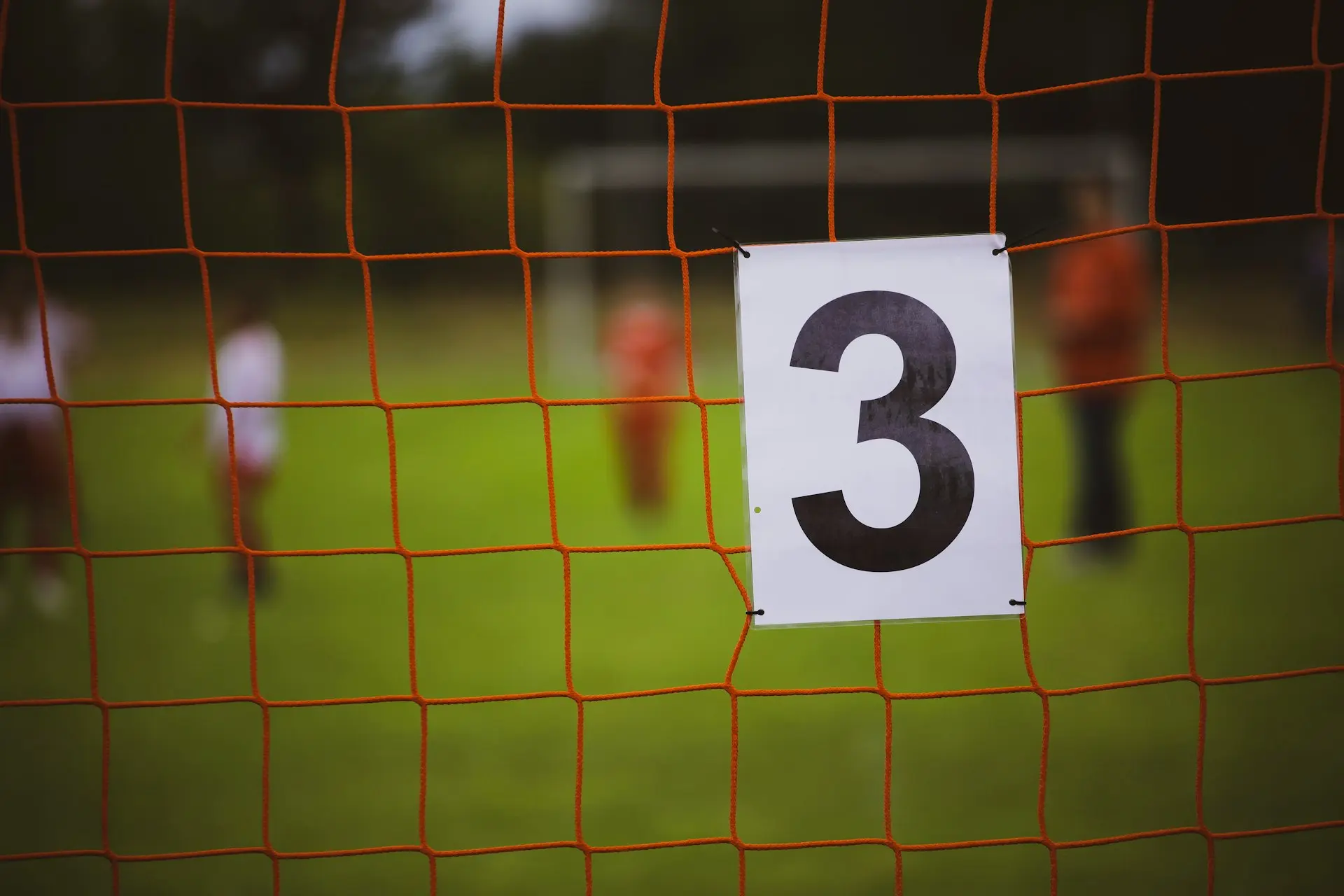 a number three sign on a soccer goal